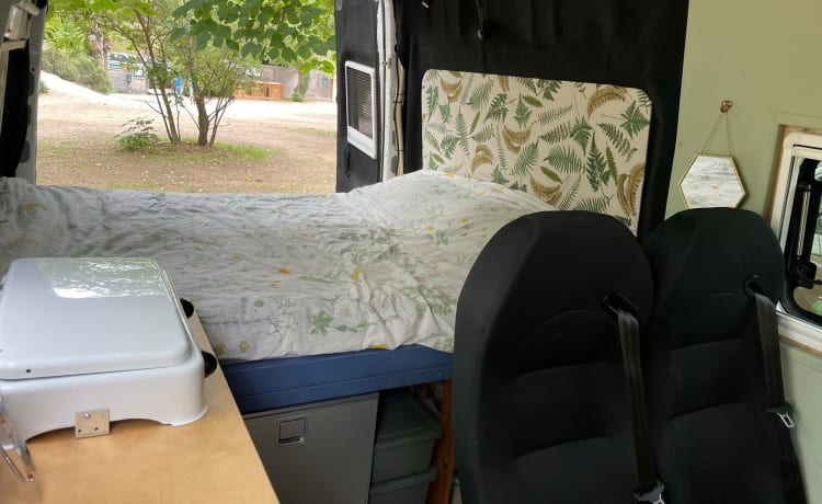 Cozy camper van with fixed bed