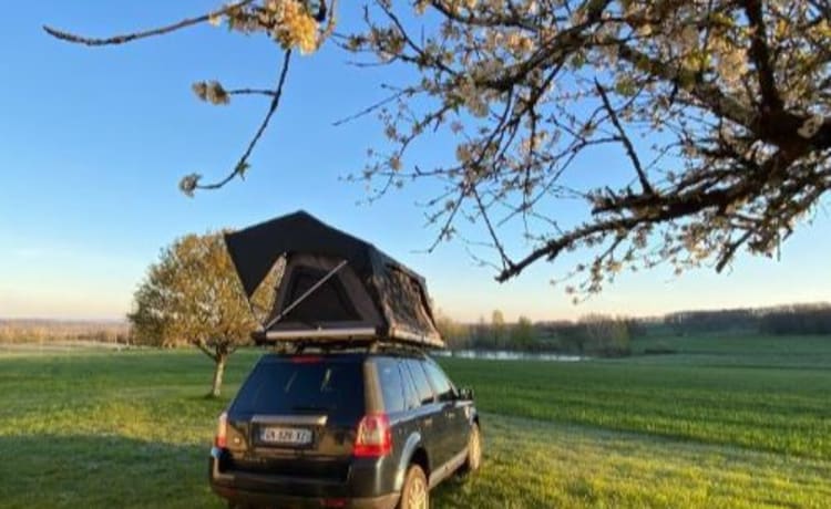 Mr. Blue Sky – Land Rover mit großem Dachzelt und voller Campingausrüstung in Frankreich