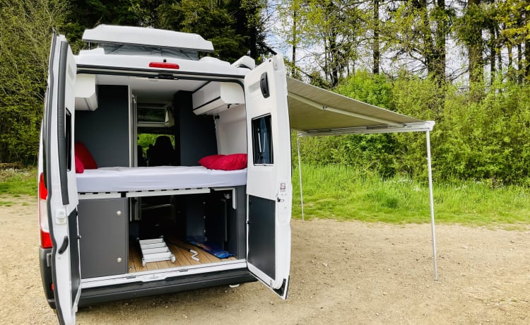 Camper van with sky roof and pop-up roof