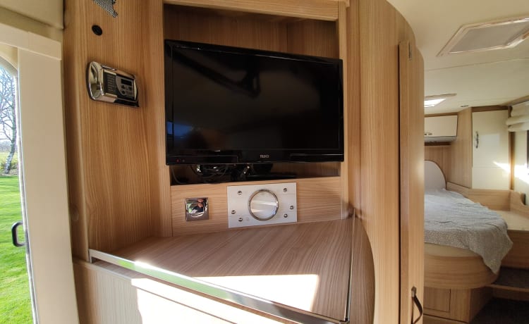 luxury camper including queen-size bed, pull-down bed and large garage and tow bar