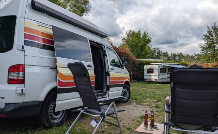 Retro Volkswagen Bus with bicycle carrier & awning