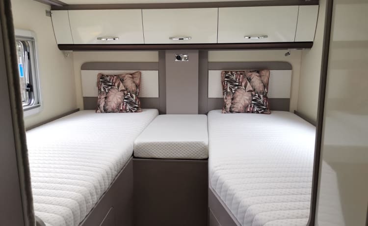 Luxury semi-integrated Burstner camper single beds & pull-down bed