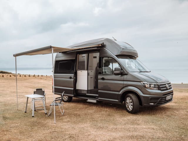 The Holiday Van – Neuf - VW Grand California - 4 Couchettes - Inclut Douche, Toilettes et Cuisine