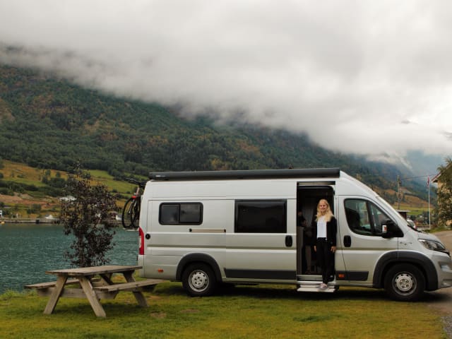 Bus camper with awning, private shower and toilet.