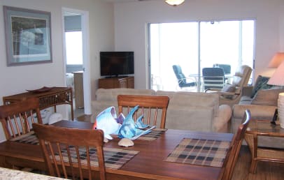 View from kitchen through dining room. Large flat-screen TV, DVD and stereo in living room