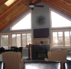 The great room has cathedral ceiling large scree TV, Bose surround sound, apple TV, & a gas fireplace.