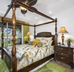 Master bedroom outfitted with a cal king 4 poster bed and exquisite Tommy Bahama bedding.