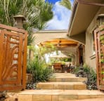 Through Hand Carved Teak Gates The Experience Begins....