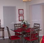 Eating bar with 3 bar stools to the left and seating for 4 at table