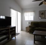 living room, with sliding door to the patio and pool