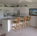 Fully equiped kitchen with serving bar and stools