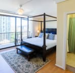 Master bedroom with king size canopy bed, a 32" TV and ipod / iphone dock.