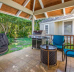 Peaceful garden side lanai with new Weber BBQ and hanging chair. Another perfect place to read and relax.