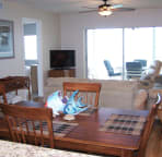 View from kitchen through dining room. Large flat-screen TV, DVD and stereo in living room