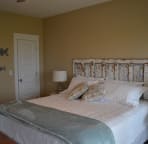The second floor master bedroom includes a extremely comfortable king sized bed and a sliding glass door to the deck.
