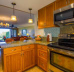 Fully equipped kitchen with stainless steel appliances, granite counters