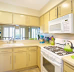 Cozy kitchen with updated appliances and quality implements and gadgets.
