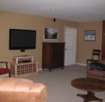 The lower level family room, has a fooseball table, wii, and an air hockey table, large TV, and Bose surround sound system.