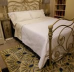 Queen size bed with quality linens in the main apartment