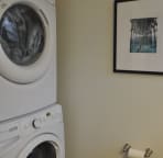 Full size washer & dryer located in 1/2 bath off foyer.