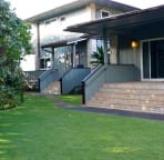 Back of the house with steps to kitchen and also downstairs master bedroom