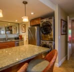 Fully equipped kitchen with stainless steel appliances, granite counters