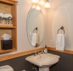 Main floor powder room with attached laundry room.