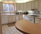 Our large kitchen with two ovens, gas stove, dishwasher, refrigerator and cooking gear.