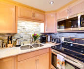 Executive kitchen with stainless steel appliances including double fridge.