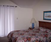 Upstairs Master Bedroom - behind the drapes are sliding glass doors to upstairs deck