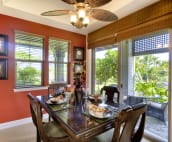 Morning Glory's tastefully decorated dining room leads to a wrap around lanai with built in Viking BBQ.
