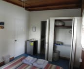 Bedroom has a Closet and Small Refrigerator