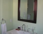 The in suite full bathroom for the main level guest room has a pedestal sink