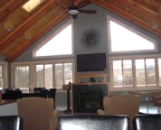 The great room has cathedral ceiling large scree TV, Bose surround sound, apple TV, & a gas fireplace.