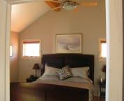 The master bedroom with a king size sleigh bed and access to the wrap around deck