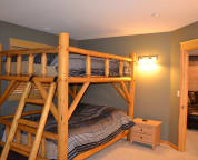 One of two queen bunk beds in basement.