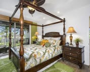 Master bedroom outfitted with a cal king 4 poster bed and exquisite Tommy Bahama bedding.