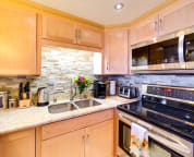 Executive kitchen with stainless steel appliances including double fridge.