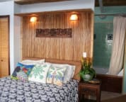 Master Bedroom with Jacuzzi Tub. King faces windows opening over ocean
