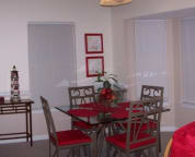 Eating bar with 3 bar stools to the left and seating for 4 at table
