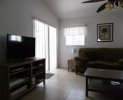 living room, with sliding door to the patio and pool