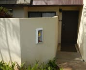 Front entrance with enclosed courtyard off Master Bedroom on left.