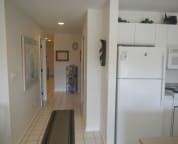 Inside hallway and new refrigerator in kitchen area