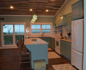 The amazing reclaimed beadboard ceiling is like a work of art in the fully-stocked kitchen.