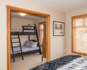 Bedroom 2 & 3 separated by wood pocket doors.