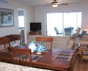 View from kitchen through dining room. Large flat-screen TV, DVD and stereo in living room
