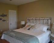 The second floor master bedroom includes a extremely comfortable king sized bed and a sliding glass door to the deck.