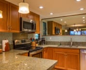 Fully equipped kitchen with stainless steel appliances, granite counters
