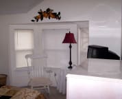 Bedroom #3 has rocking chair in the bay window area