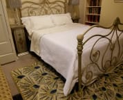 Queen size bed with quality linens in the main apartment